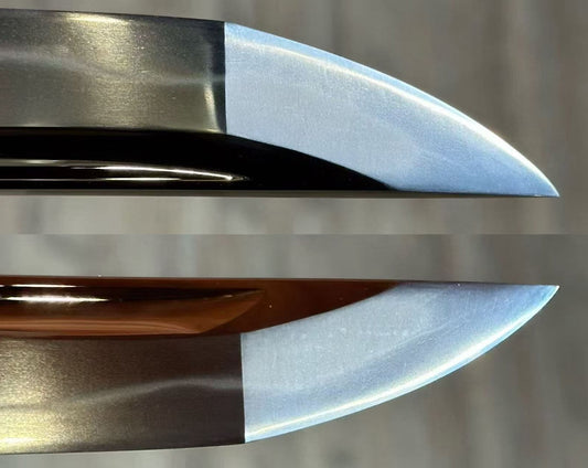 Close view of a Japanese sword blade showing the kissaki, hamon and steel grain